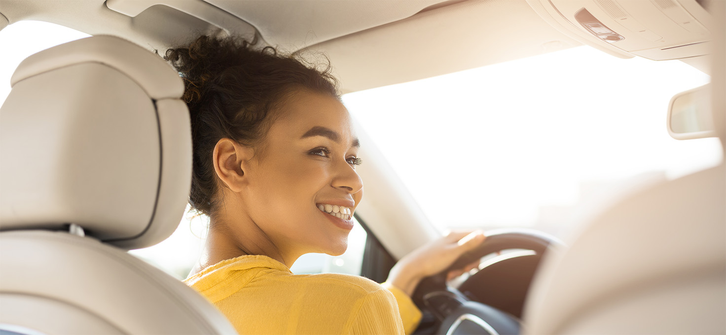 Hands gripping a steering wheel.