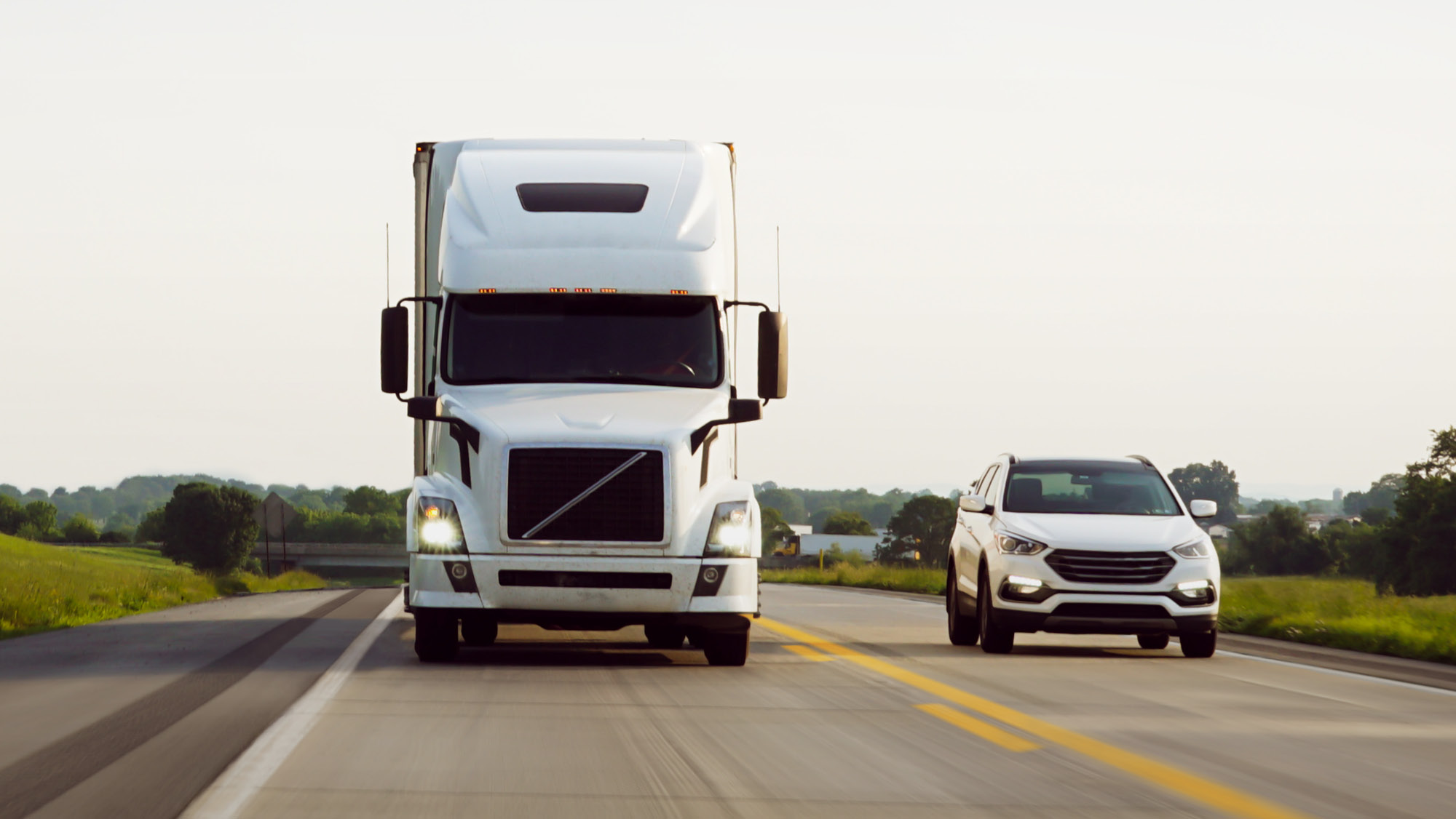 SUV passing a large commercial truck